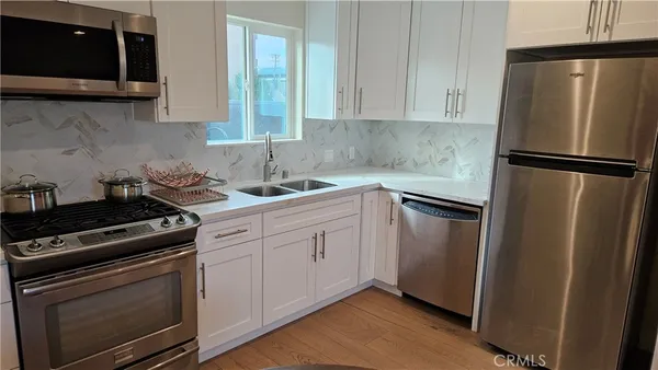 a kitchen with a stove microwave and refrigerator