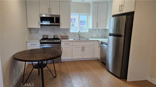 a kitchen with stainless steel appliances a refrigerator stove and microwave