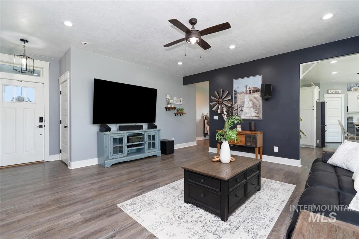 15015 Leon Lane Caldwell, ID 83607 - Photo 15 of 44 Spacious living area featuring wood-finish flooring, recessed lighting, and a dark ceiling fan with light