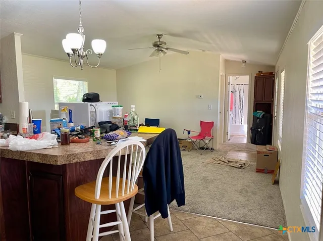 a view of a dining room with furniture and a chandelier