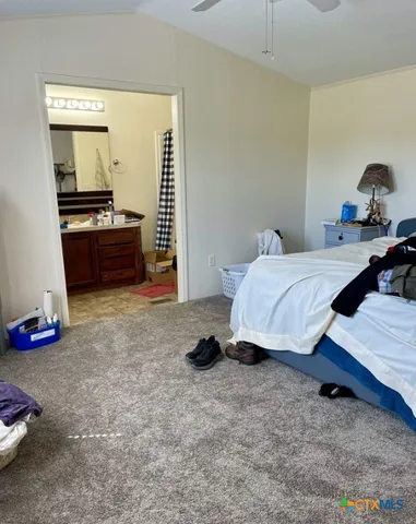 a bed room with a bed and a chair