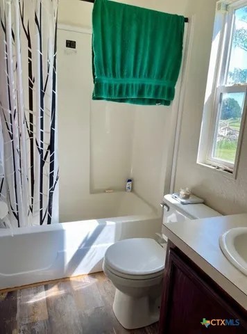 a bathroom with a sink a toilet and bathtub
