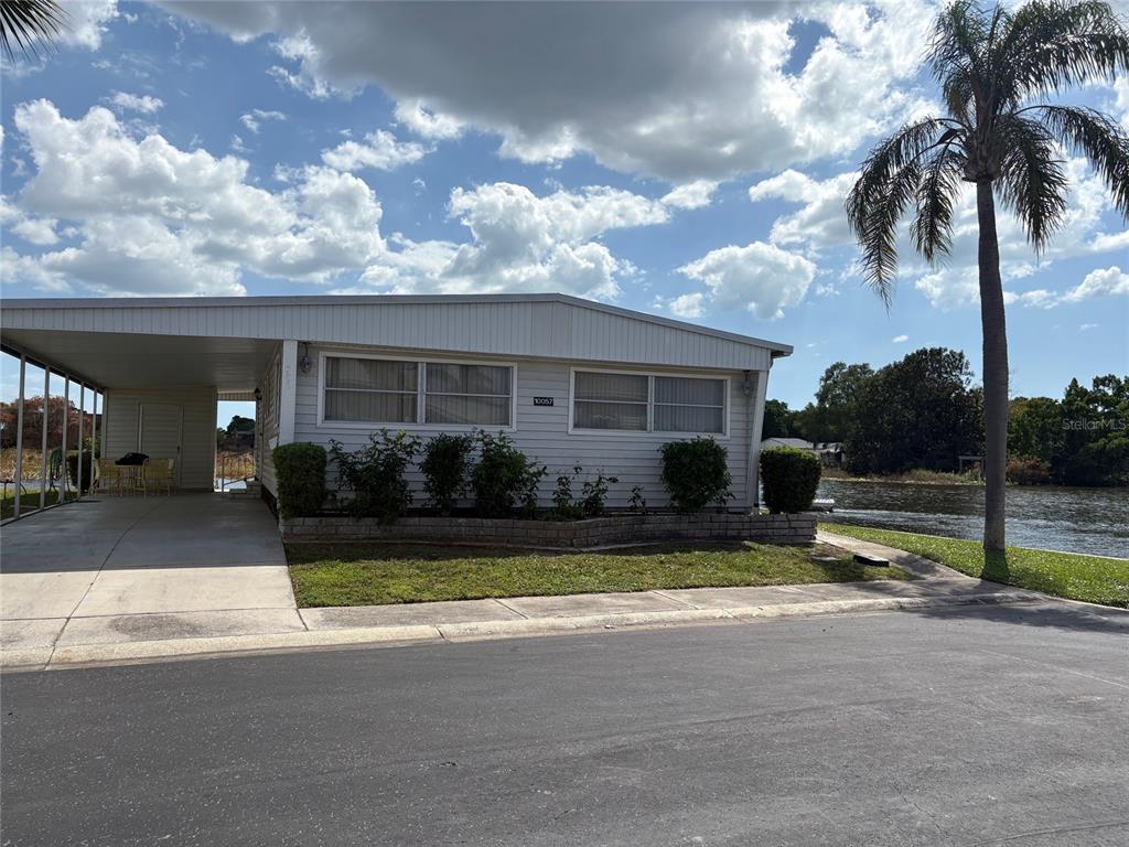 10057 110th Place, Unit 243 Largo, FL 33773 - Photo 1 of 32 a view of a house with backyard and porch