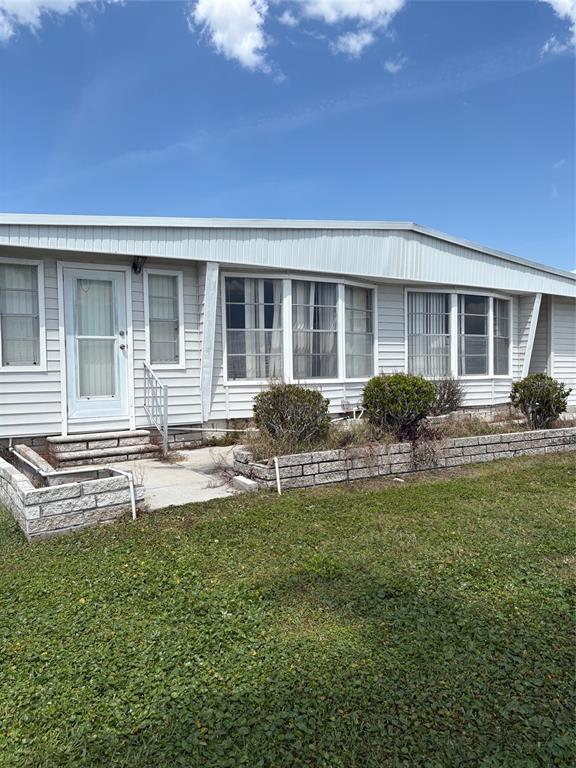 10057 110th Place, Unit 243 Largo, FL 33773 - Photo 11 of 32 a front view of a house with swimming pool and porch