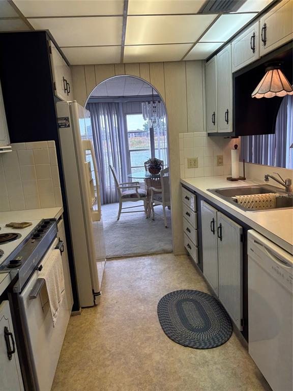 10057 110th Place, Unit 243 Largo, FL 33773 - Photo 14 of 32 a kitchen with stainless steel appliances granite countertop a sink stove and cabinets