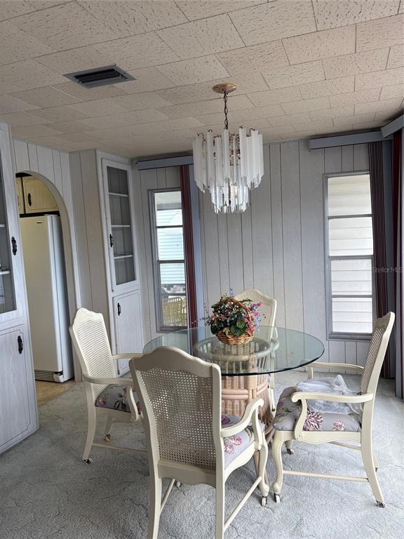 10057 110th Place, Unit 243 Largo, FL 33773 - Photo 16 of 32 a view of a dining room with furniture and chandelier