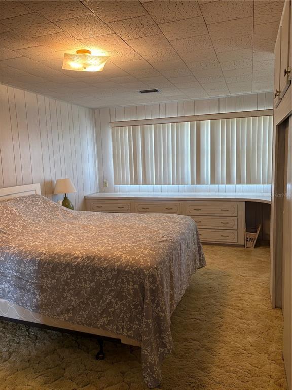10057 110th Place, Unit 243 Largo, FL 33773 - Photo 25 of 32 a bedroom with a bed and a window