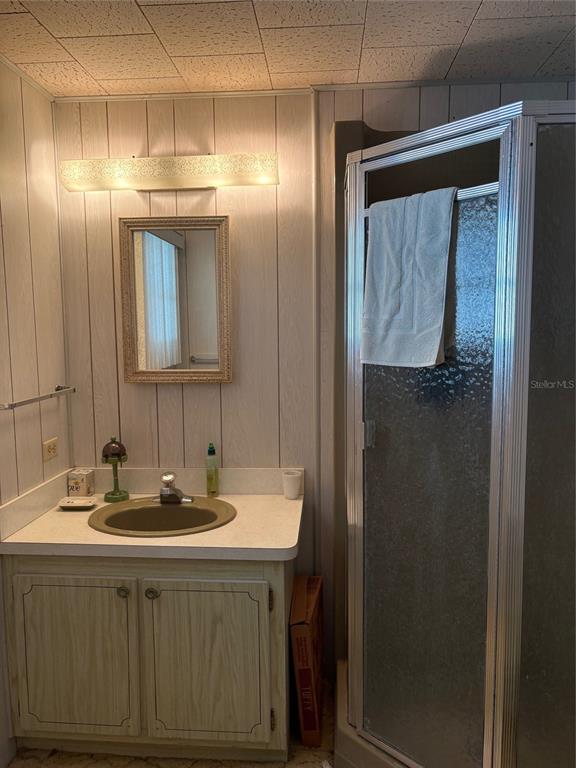 10057 110th Place, Unit 243 Largo, FL 33773 - Photo 26 of 32 a bathroom with a sink and a mirror