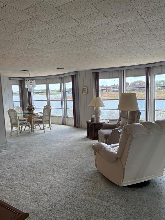10057 110th Place, Unit 243 Largo, FL 33773 - Photo 29 of 32 a living room with furniture and a large window