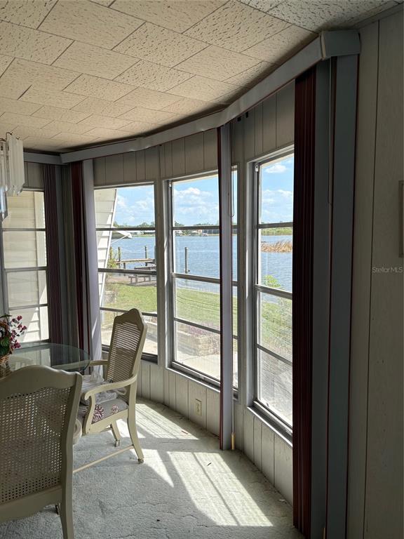 10057 110th Place, Unit 243 Largo, FL 33773 - Photo 32 of 32 a living room with furniture and a floor to ceiling window