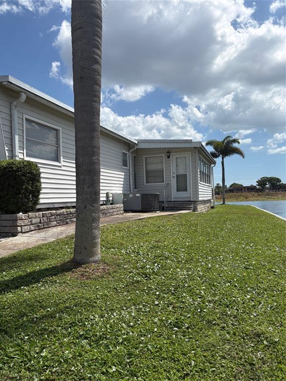 10057 110th Place, Unit 243 Largo, FL 33773 - Photo 7 of 32 a front view of house with yard and green space