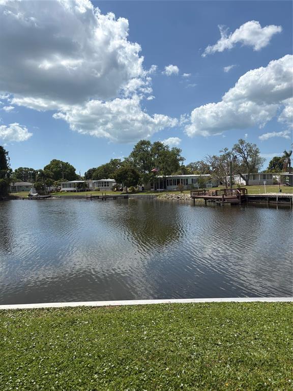 10057 110th Place, Unit 243 Largo, FL 33773 - Photo 9 of 32 a view of a lake with houses in the back