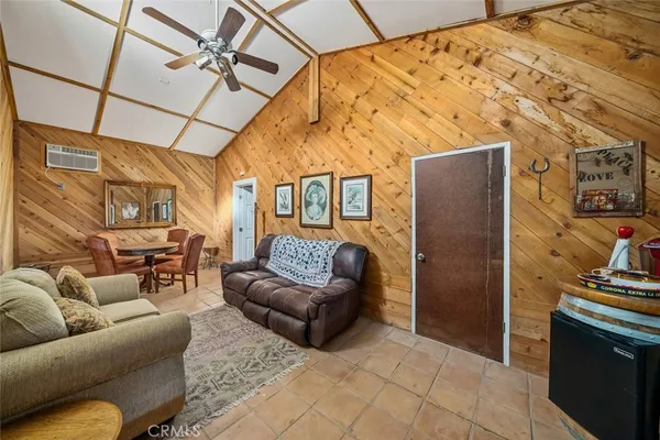 a kitchen with stainless steel appliances a sink a stove a refrigerator cabinets and a dining table