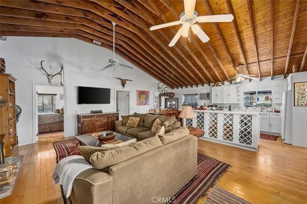 a living room with stainless steel appliances kitchen island granite countertop furniture and a kitchen view