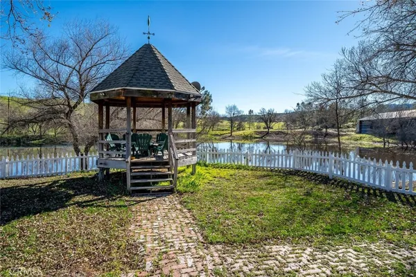 a view of a park with bench and trees