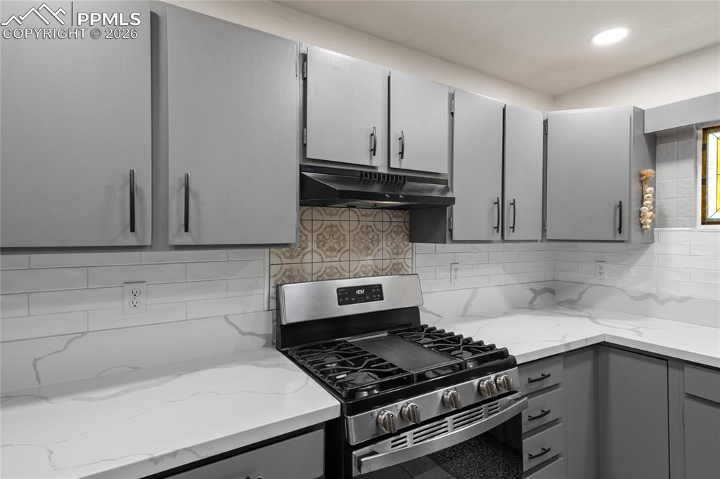 756 Spring Valley Drive Divide, CO 80814 - Photo 11 of 48 a kitchen with granite countertop a stove sink and cabinets