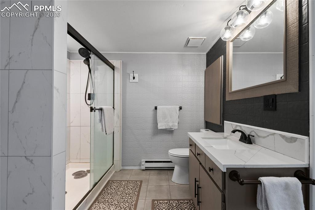756 Spring Valley Drive Divide, CO 80814 - Photo 14 of 48 a bathroom with a granite countertop sink a toilet a mirror and shower