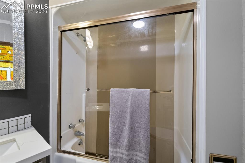 756 Spring Valley Drive Divide, CO 80814 - Photo 21 of 48 a bathroom with a glass shower door and a mirror