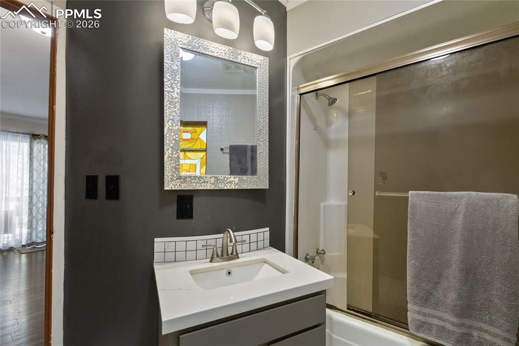 756 Spring Valley Drive Divide, CO 80814 - Photo 22 of 48 a bathroom with a sink a mirror and a shower