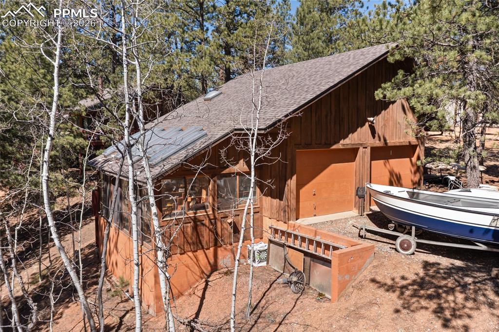 756 Spring Valley Drive Divide, CO 80814 - Photo 34 of 48 a roof deck with table and chairs with wooden floor and fence