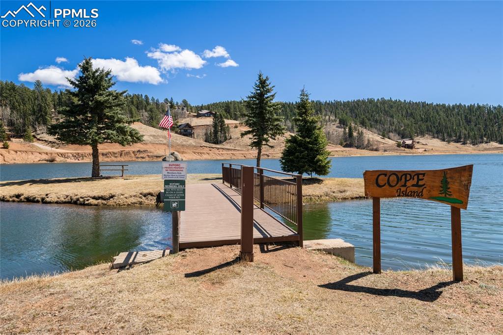 756 Spring Valley Drive Divide, CO 80814 - Photo 38 of 48 a view of a lake with a house in the background