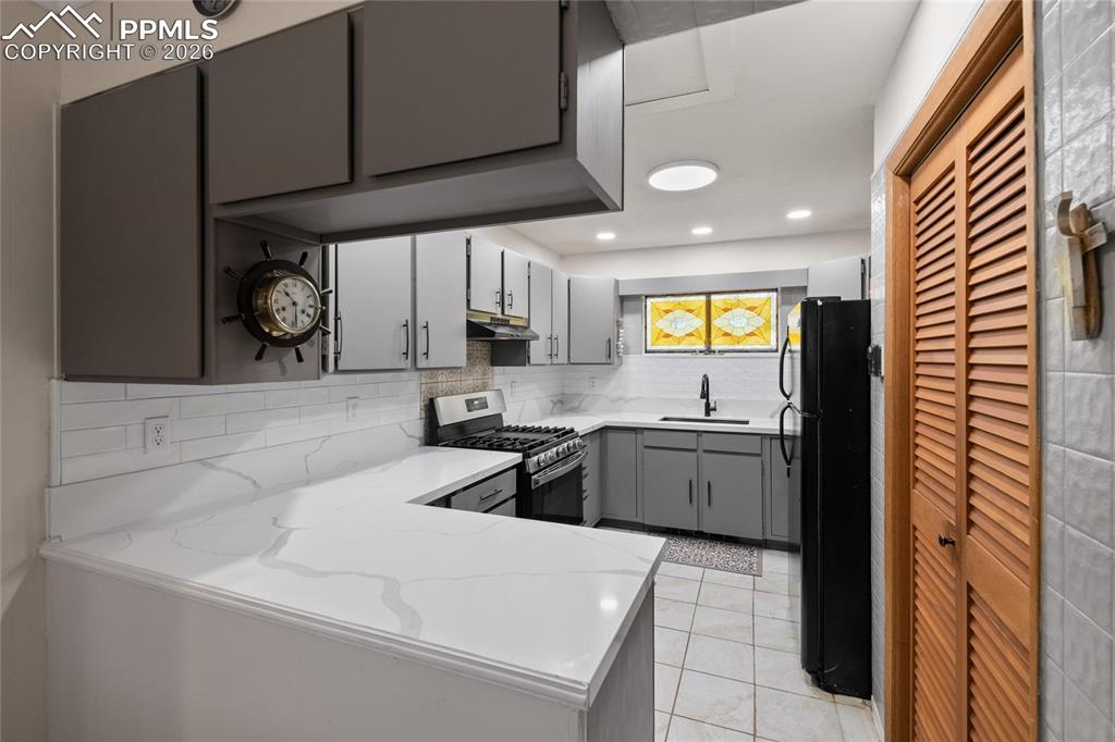 756 Spring Valley Drive Divide, CO 80814 - Photo 9 of 48 a kitchen with stainless steel appliances granite countertop a sink and cabinets