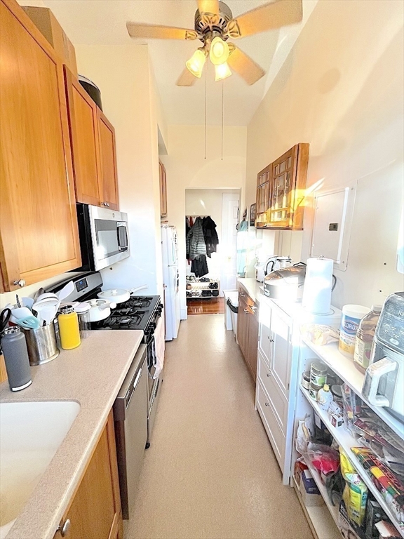 371 Harvard Street, Unit 3C Cambridge, MA 02138 - Photo 14 of 27 a living room with furniture and a flat screen tv