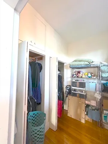a view of walk in closet with clothes and shoes