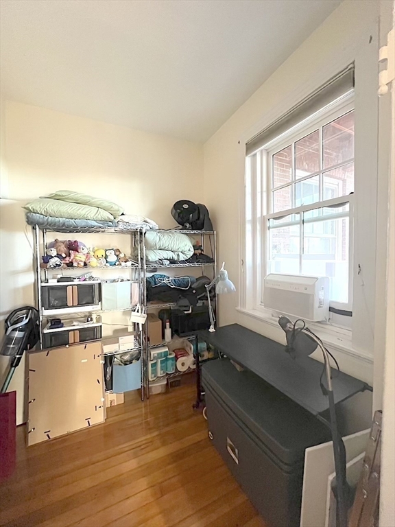 371 Harvard Street, Unit 3C Cambridge, MA 02138 - Photo 21 of 27 a room with gym equipment and a window