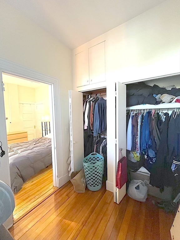 371 Harvard Street, Unit 3C Cambridge, MA 02138 - Photo 22 of 27 a view of walk in closet with clothes and shoes