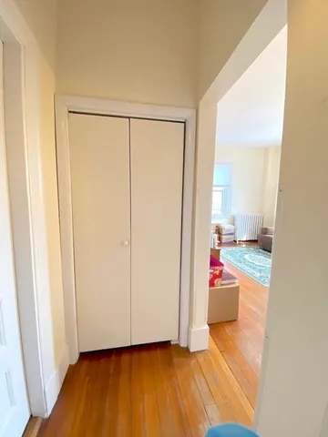 a view of a room with wooden floor and bathroom