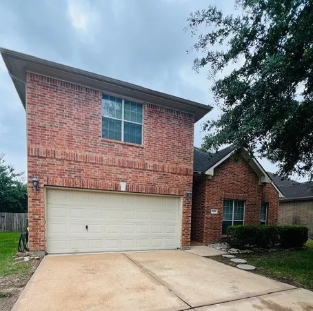 a front view of a house with garage