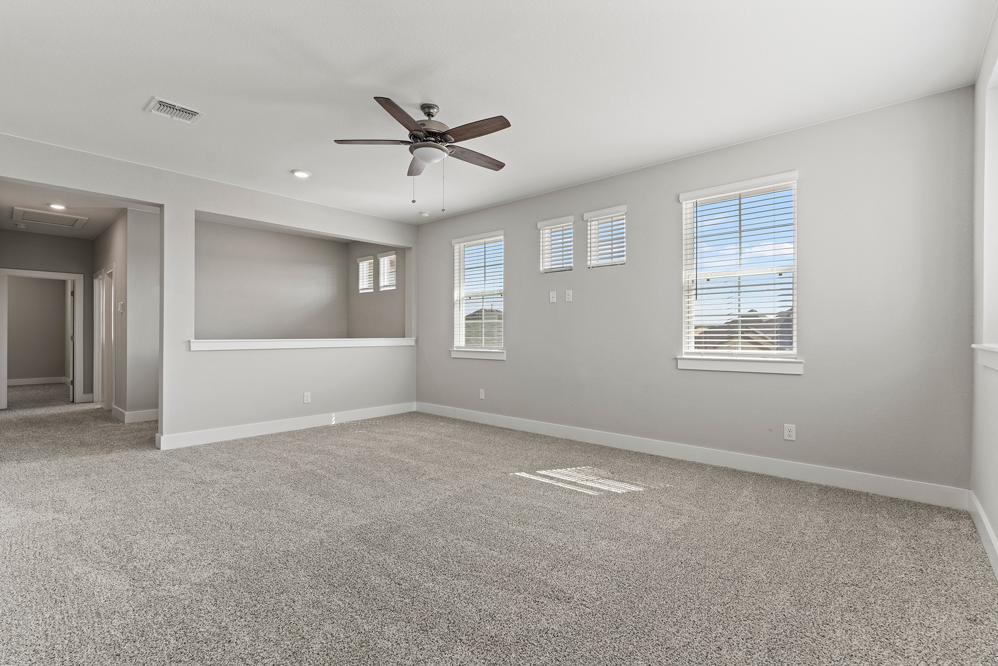 2112 Tobiano Trace Georgetown, TX 78633 - Photo 28 of 40 Unfurnished room featuring light colored carpet, a ceiling fan, and recessed lighting