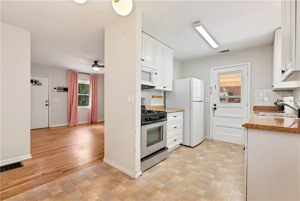a kitchen with stainless steel appliances a refrigerator and a stove top oven