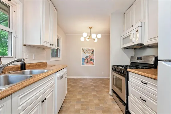 a kitchen with stainless steel appliances granite countertop a sink stove and cabinets