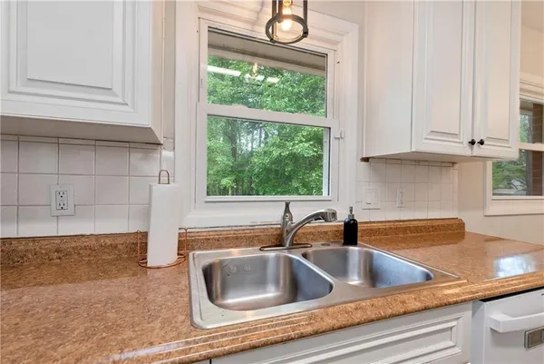 a kitchen with a sink and cabinets