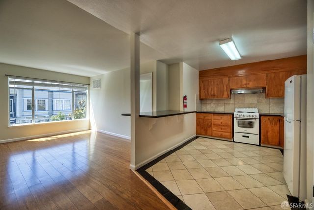 a kitchen with stainless steel appliances granite countertop refrigerator sink and cabinets