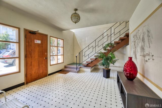 a living room with stainless steel appliances furniture a dining table and chairs