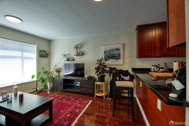 a living room with furniture kitchen view and a table