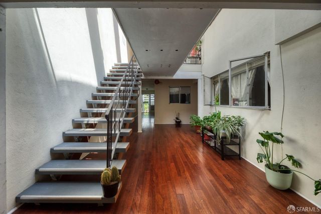 a kitchen with stainless steel appliances a refrigerator and a stove top oven