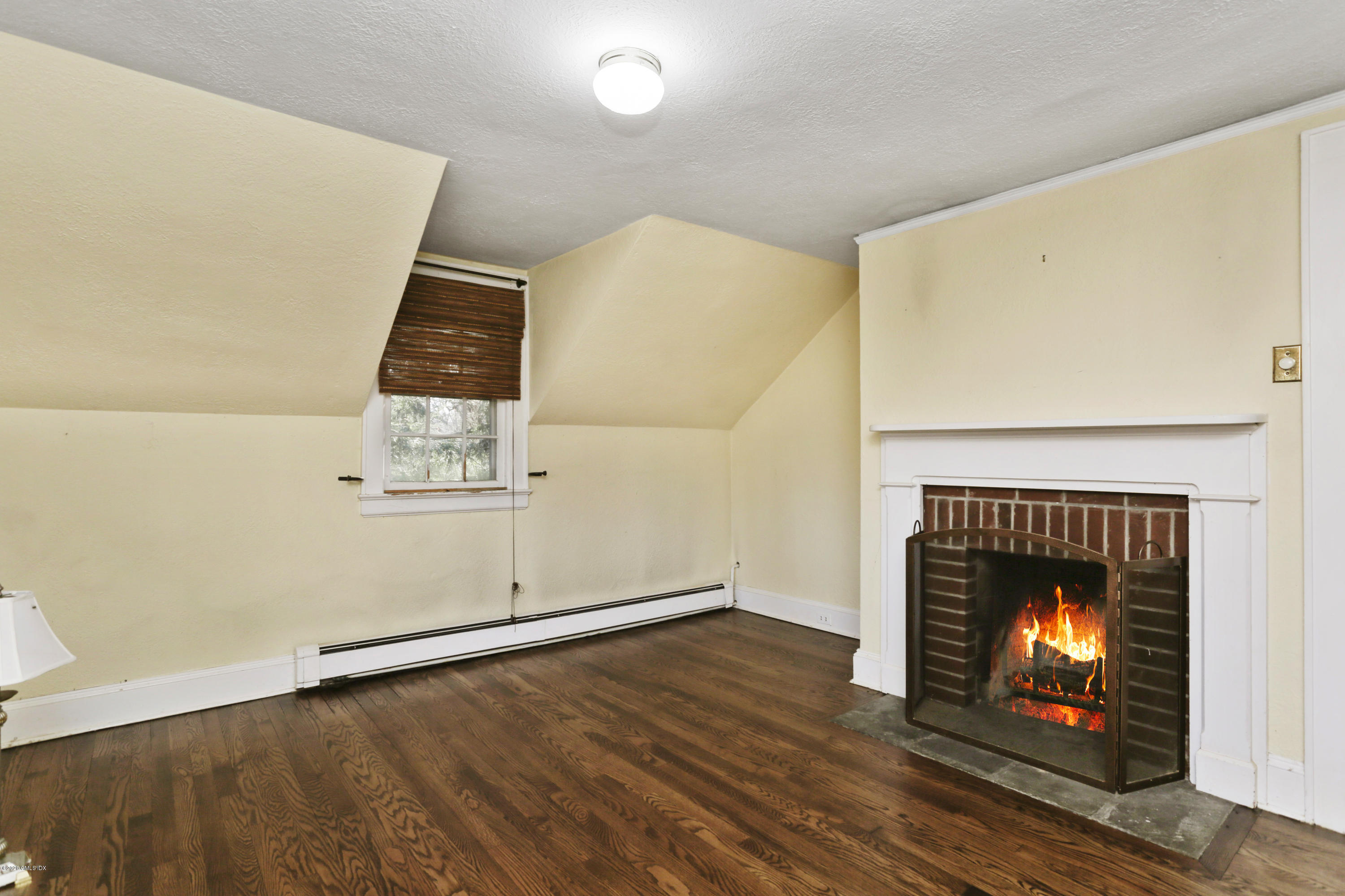 59 Cherry Valley Road Greenwich, CT 06831 - Photo 14 of 19 a view of an empty room with wooden floor fireplace and a window