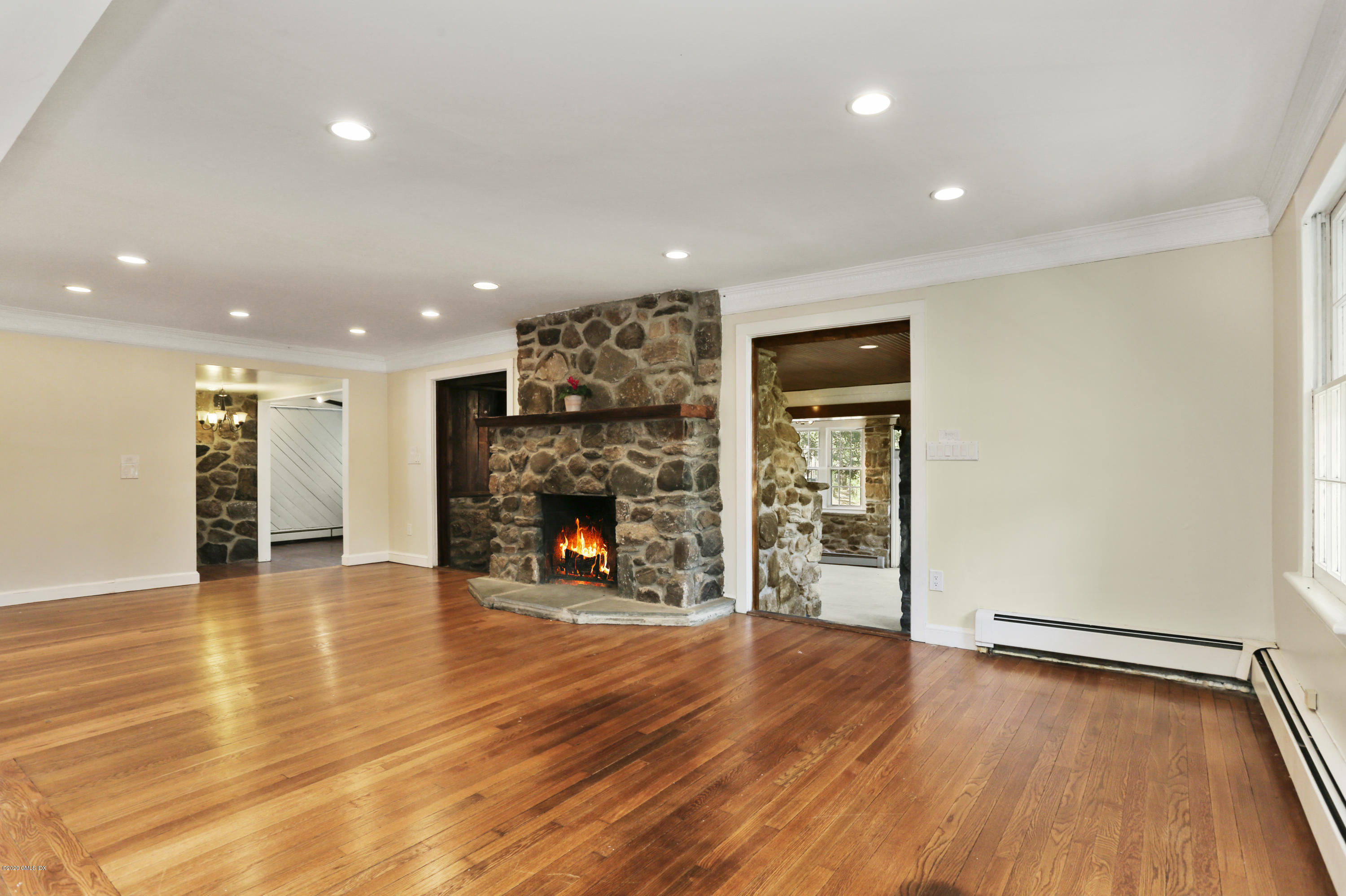 59 Cherry Valley Road Greenwich, CT 06831 - Photo 4 of 19 a view of an empty room with wooden floor and a fireplace