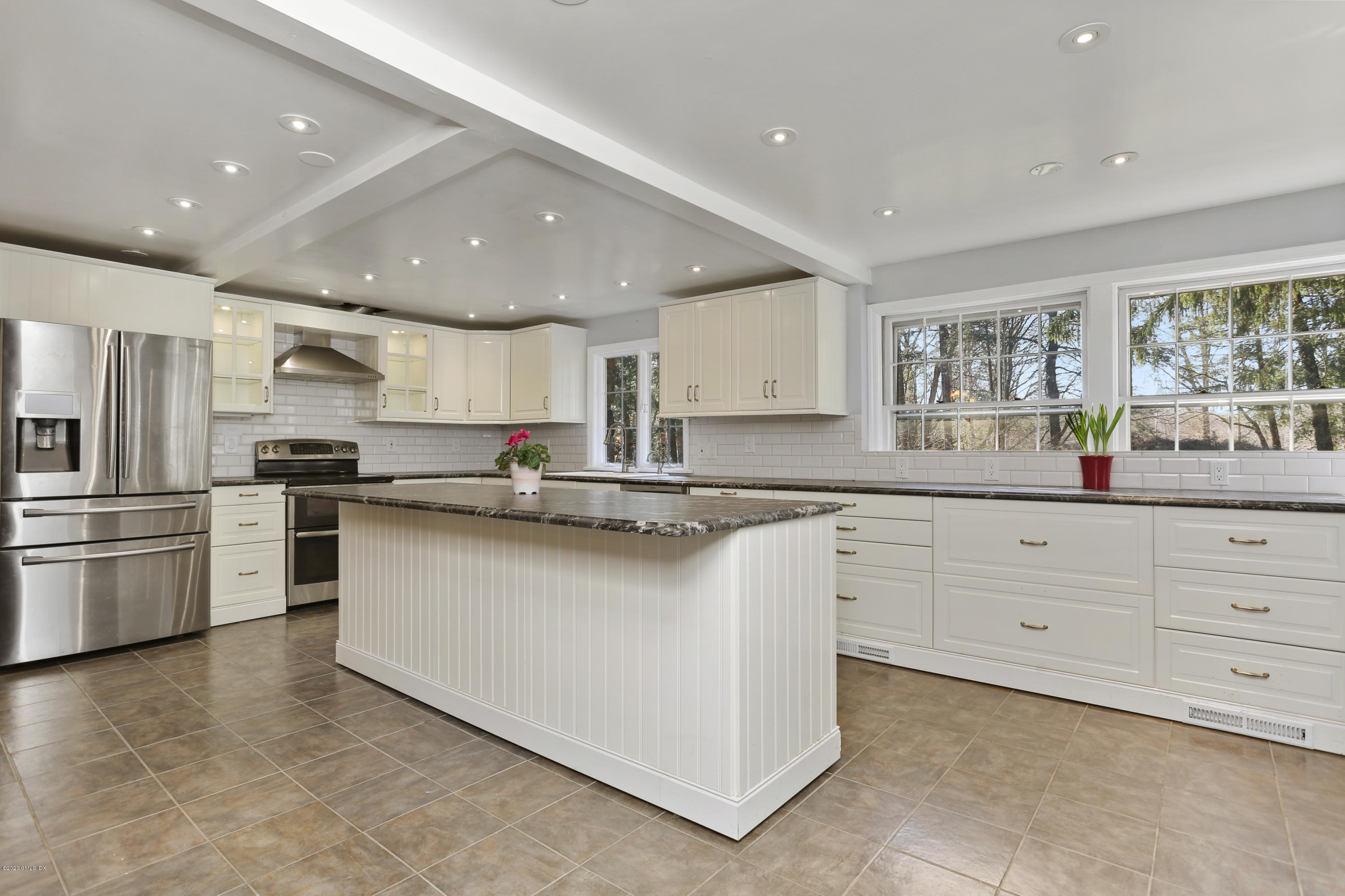 59 Cherry Valley Road Greenwich, CT 06831 - Photo 5 of 19 a kitchen with granite countertop white cabinets and stainless steel appliances