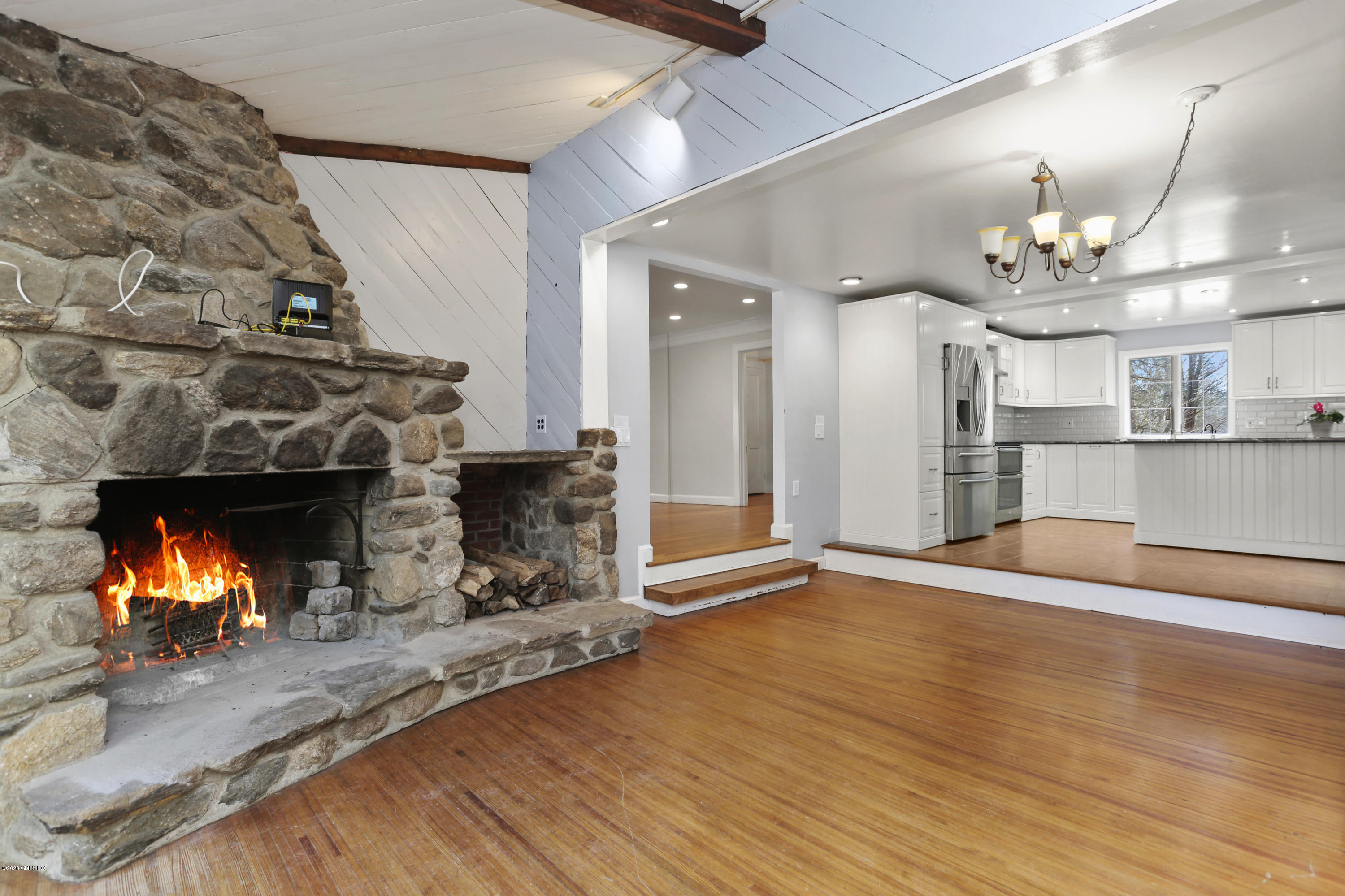 59 Cherry Valley Road Greenwich, CT 06831 - Photo 6 of 19 an empty room with wooden floor and a fireplace