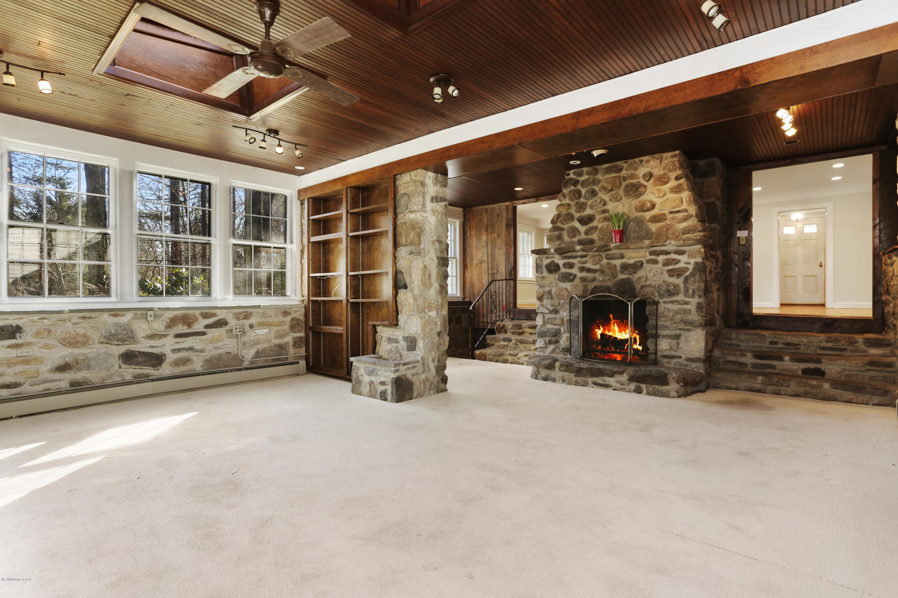 59 Cherry Valley Road Greenwich, CT 06831 - Photo 7 of 19 a view of an empty room with a fireplace and a window