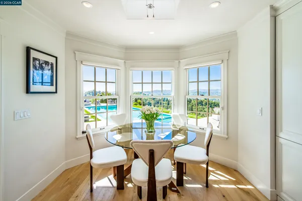 a living room with large windows and a table