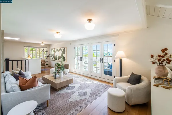 a spacious bedroom with a bed and a flat screen tv