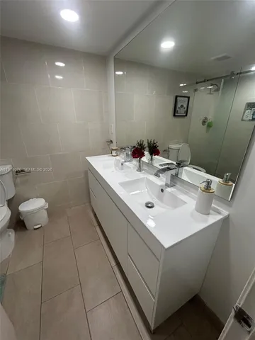 a bathroom with a sink toilet and a mirror