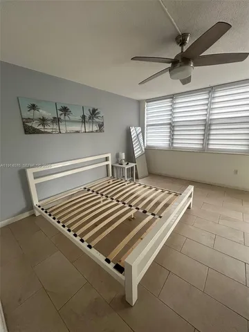 a view of room with a window and ceiling fan