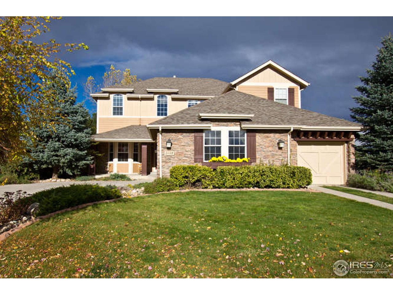 3460 Rookery Road Fort Collins, CO 80528 - Photo 1 of 23 a front view of a house with a yard